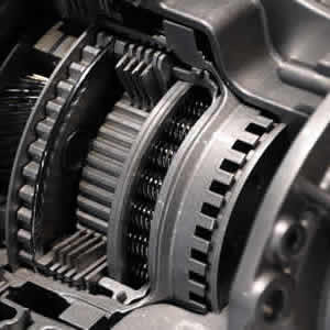 Close-up of car gear box, showing intricate gears and mechanical components.